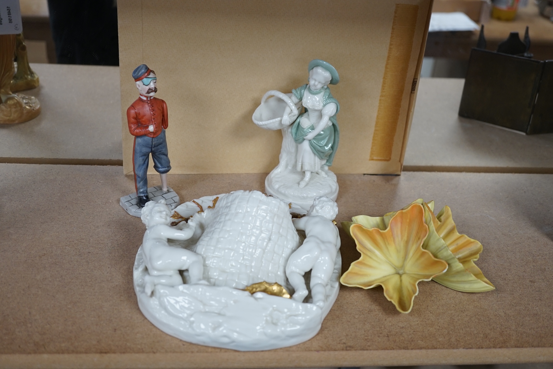 A Royal Worcester gilt figural wall pocket, two figures and a petal ornament, largest 22cm high. Condition - fair to good